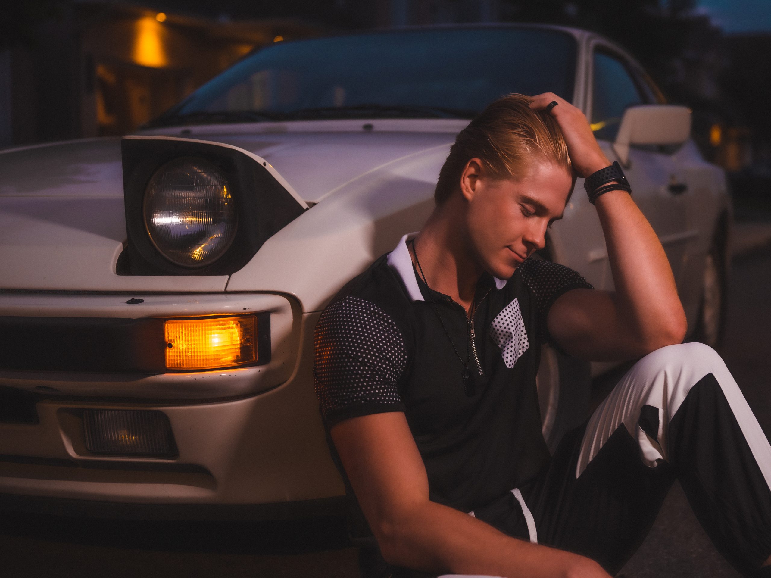 Fashion and Automotive Content Photography of a young white male model posing infront of a vintage Porsche Sportscar